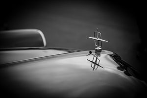 Classic Lincoln emblem above polished automobile hood