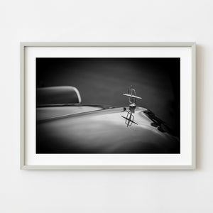 Lincoln Continental hood ornament with reflection in black and white