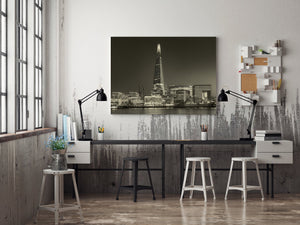 London skyline and smooth Thames water beneath the Shard at night
