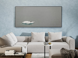 Antarctic penguin and pale ice floe beneath a wide expanse of grey water