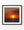Lone sailboat silhouetted beside the sun over an ocean at red-orange sunset