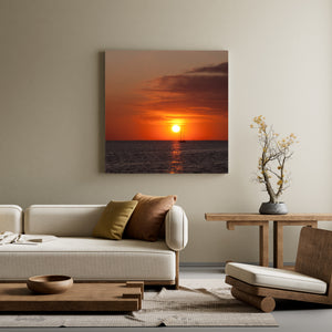 Warm orange sunset and shimmering reflection across ocean waves