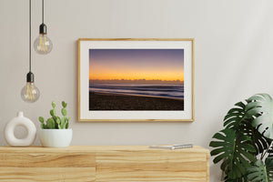 Long Reef Beach coastal sunrise with blue-grey surf and warm morning light