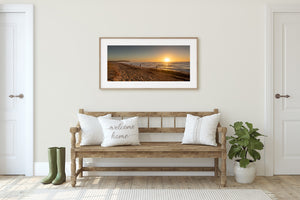 Australian coastal photograph of beach walkers beside sunlit ocean surf