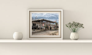 Historic abandoned gas station with diverse era pumps
