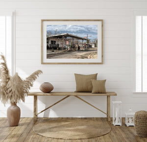 Overgrown weeds around abandoned gas service station