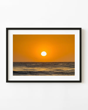 California ocean sunset with warm orange sky