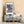 Love your enemies sign in focus with a New York pedestrian blurred behind it
