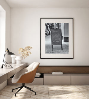 Monochrome New York street scene centred on a handwritten Matthew 5:44 sign