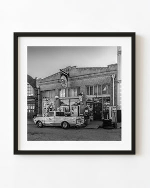 Vintage street scene in Lowell Arizona with old gas station signage black and white