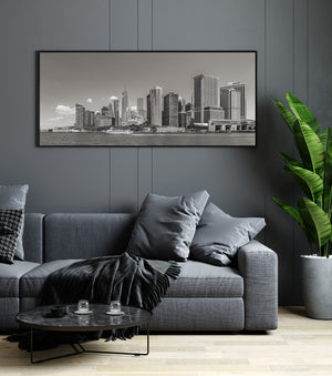 Lower Manhattan cityscape with waterfront buildings and a boat wake