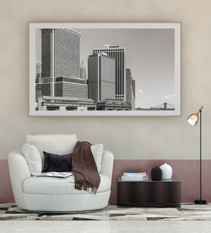 Black and white photograph of layered New York buildings along the waterfront
