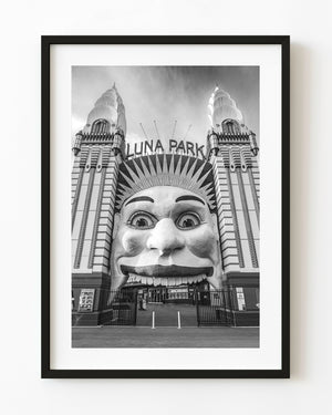 Luna Park Sydney entrance with its smiling face and twin towers in black and white