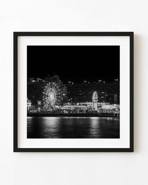 Luna Park Sydney Ferris wheel and waterfront lights reflected in harbour water at night