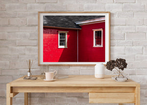 Lunenburg house windows with strong red siding and angular roof shadows
