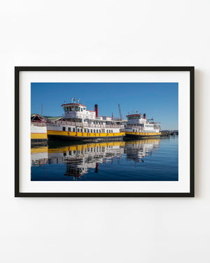 Aucocisco III and Wabanaki ferries reflected in blue harbour water in Maine