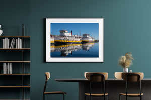 Yellow ferry hulls cast bright reflections across calm blue water