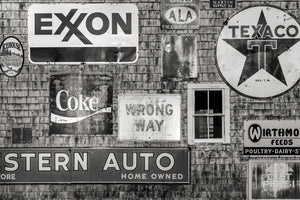 Weathered Coca Cola sign mounted on wooden building exterior in Maine
