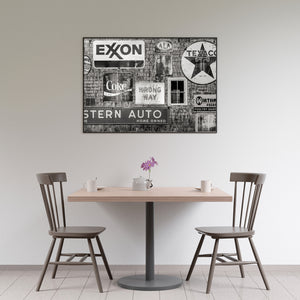 Black and white image of layered Americana roadside advertising signs