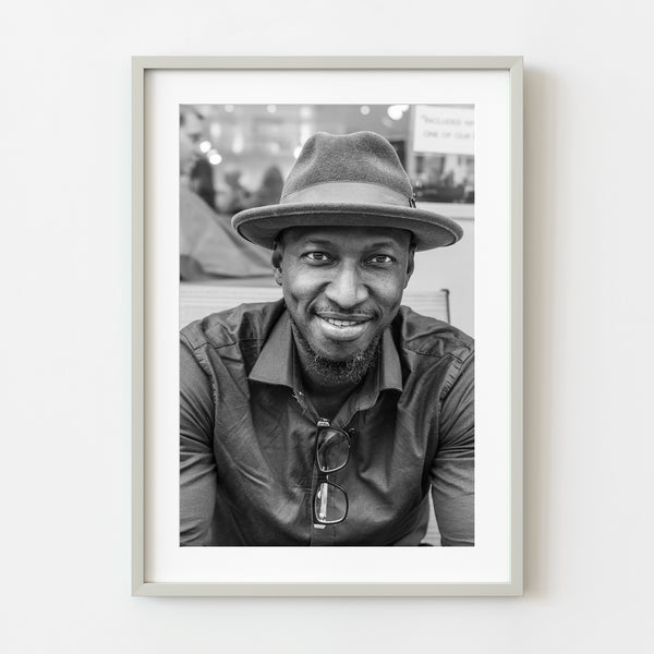 Man sitting by barber shop New York City wall art