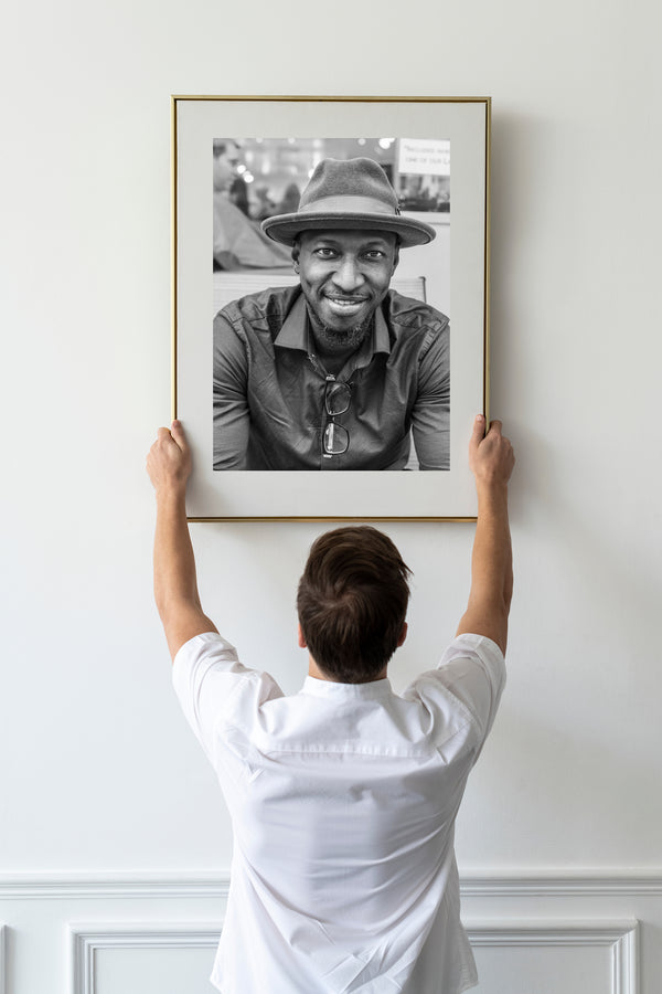 Man smiling by barber shop NYC black and white