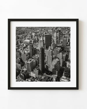 Black and white aerial photograph of densely packed Manhattan skyscrapers