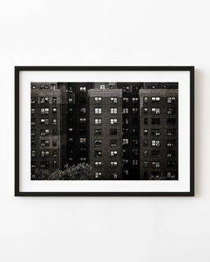 Monochrome Manhattan brick apartment facade with repeating windows