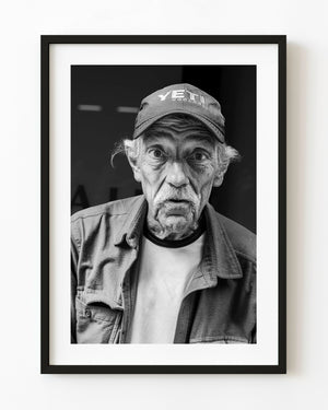 Black and white street portrait of an older man in Manhattan