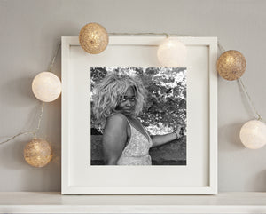 Woman standing near foliage in Manhattan black and white