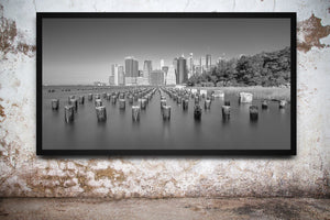 Panoramic black and white photograph of Manhattan from Brooklyn Bridge Park
