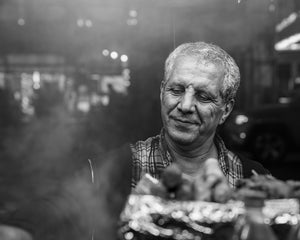 Street vendor preparing food at night in New York City