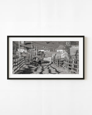 Black and white photograph of a man and woman beside a horse-drawn cart in Maramureș