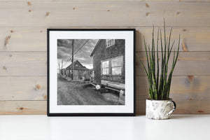Fishing shacks line a quiet Martha’s Vineyard lane beneath overhead wires