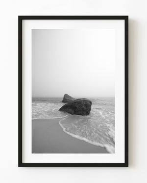 Black and white Martha’s Vineyard shoreline with two rocks surrounded by surf and mist