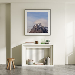 Cloud brushes a snow-streaked mountain summit above steep rock faces