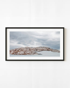 Snow surrounds a low rocky ridge in Argentina’s Martial Mountains