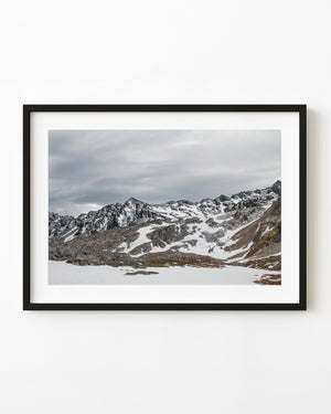 A helicopter flies beneath snow-covered Martial Mountains near Ushuaia