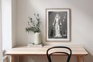 Mary with open hands seen through steamed glass in black and white