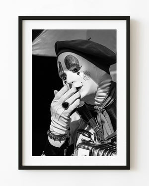 Masked Toronto accordion busker raises a gloved hand in a black and white portrait