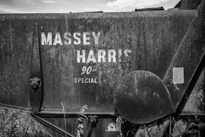 Weathered agricultural machinery branding on prairie farm