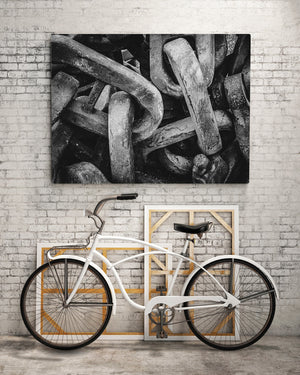 Angled perspective of massive chains against a stark, contrasting background, highlighting their architectural grandeur.