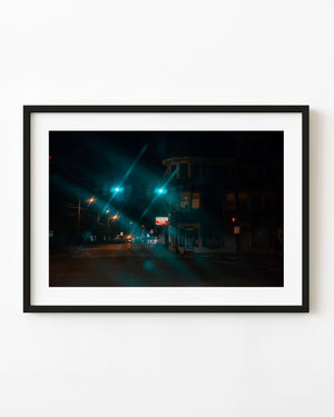 Quiet Medfield Massachusetts street at night beneath green traffic lights