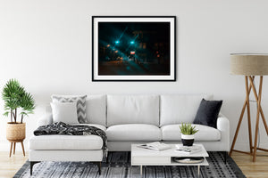 Night street photograph with green signals and warm lamps fading into the distance