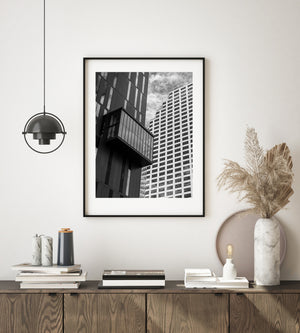 Dark vertical panels and a bright gridded tower form an urban architectural study