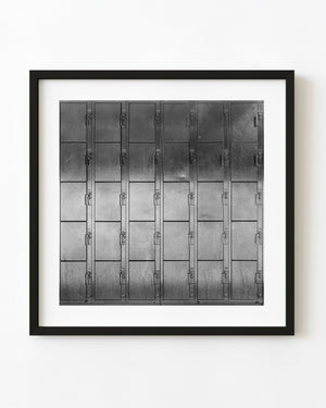 Black and white photograph of numbered metal lockers arranged in a grid