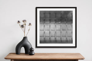 Numbered lockers form a geometric pattern in monochrome
