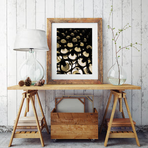 Golden bottle shoulders contrast with deep shadows in a wine-cellar study