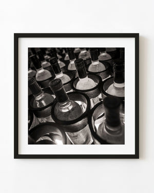 Rows of wine bottles in old Mexican cellar sepia tone