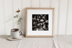 Sepia toned still life of wine bottles in circular holders