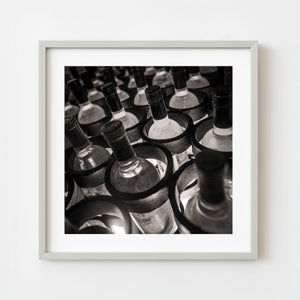 Rows of wine bottles in old Mexican cellar sepia tone